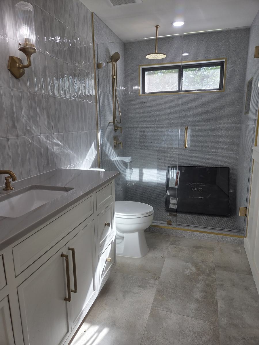 Completed bathroom with custom vanity and tile shower